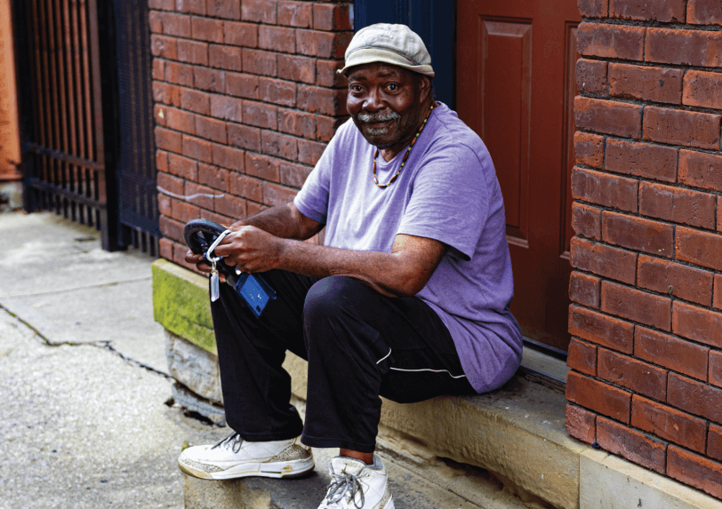 man sitting on his front step