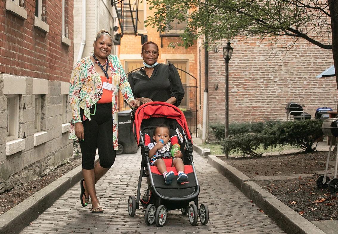 two women with a baby in a scroller