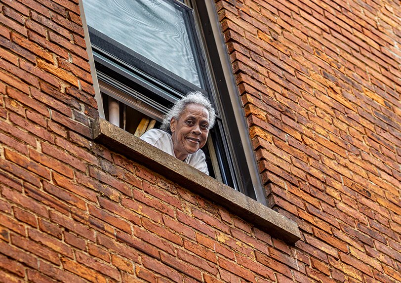 woman leaning her head out of the window