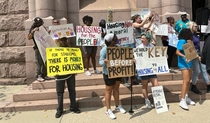 community members protesting outside of city hall